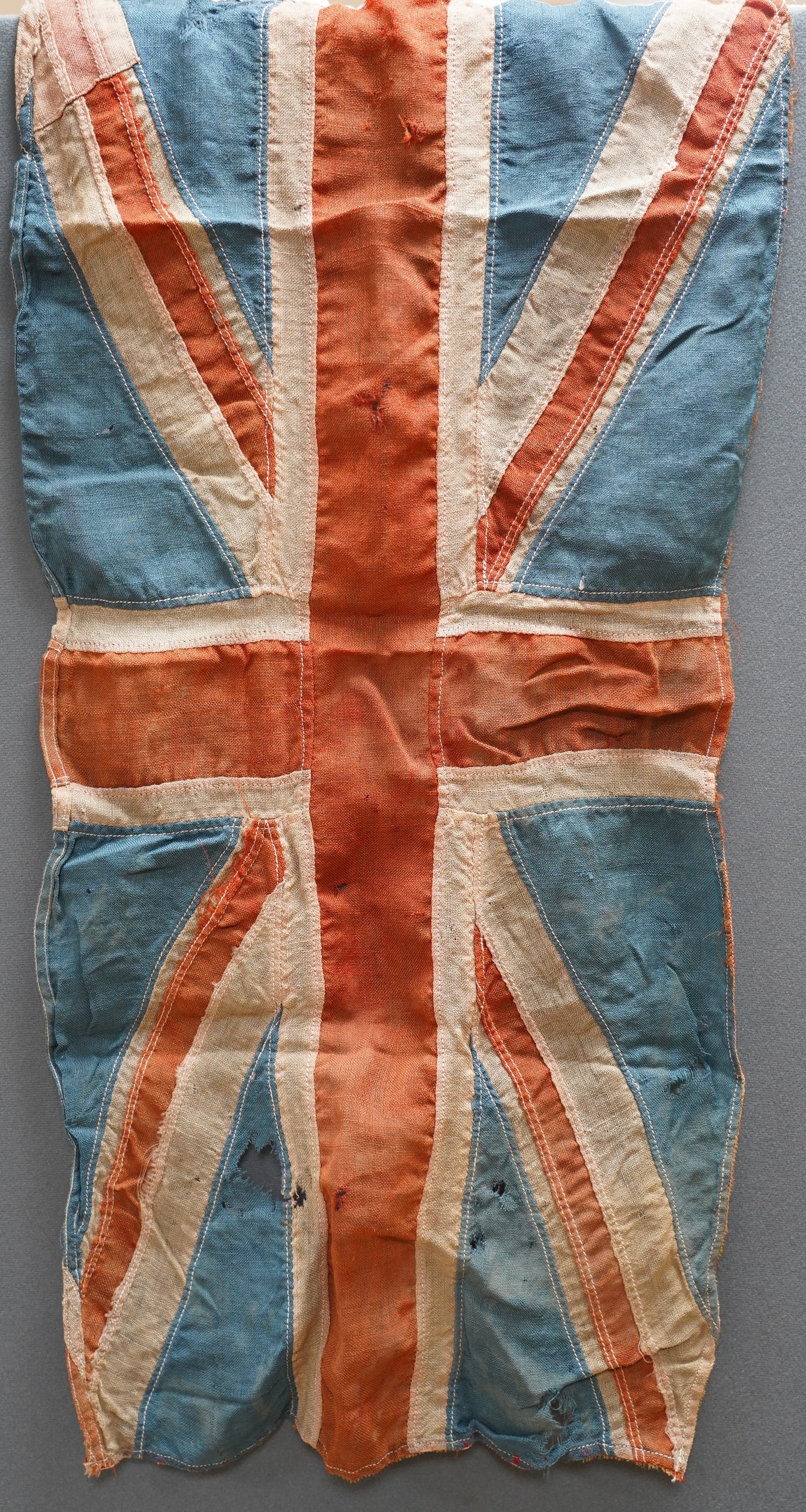 Eight mostly mid 20th century Union Jack flags, one celebrating Queen Victoria’s Diamond Jubilee, together with a Saint George’s cross and a string of Union flag bunting. Condition - poor to good